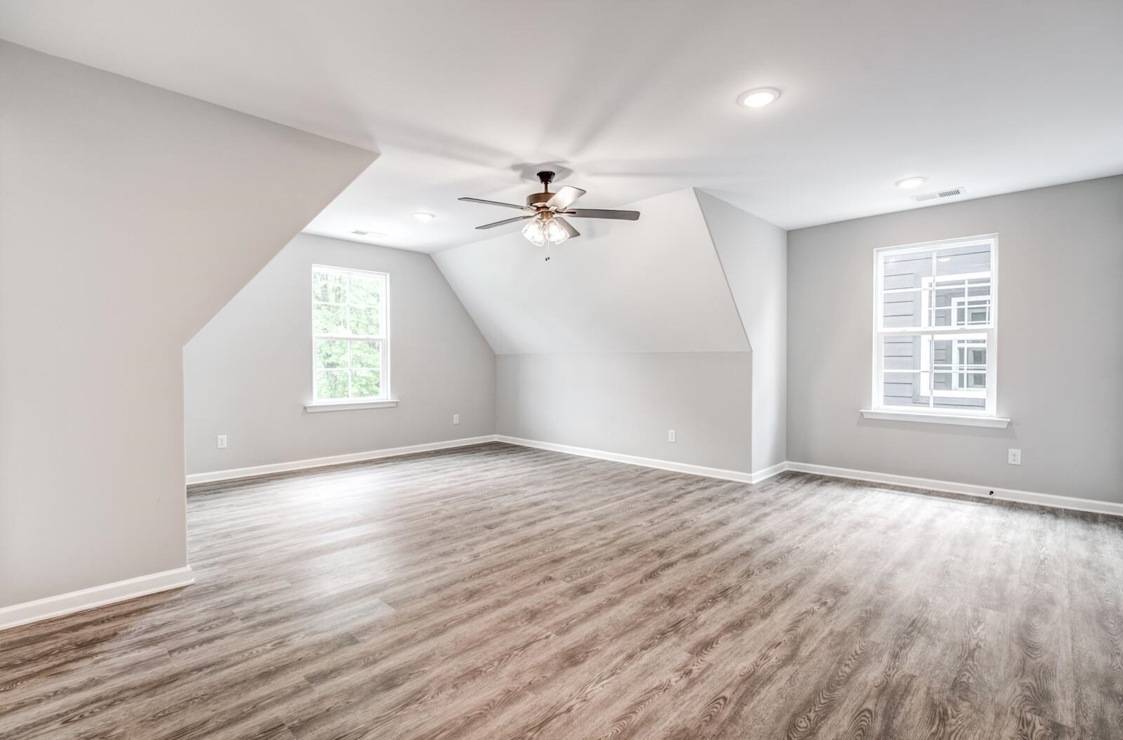 100 Blue Street Oakland, TN 38060 - Photo 34 of 40 an empty room with windows and a ceiling fan