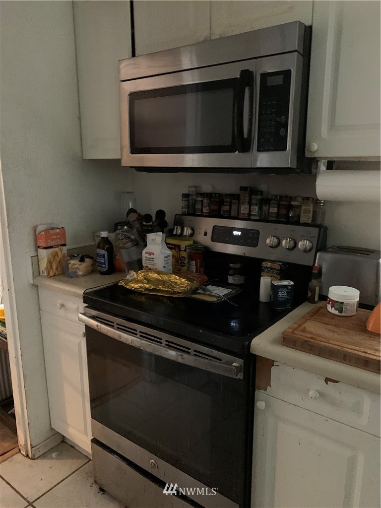 3216 Southeast 5th Street Renton, WA 98058 - Photo 13 of 18 a kitchen with a stove and a microwave
