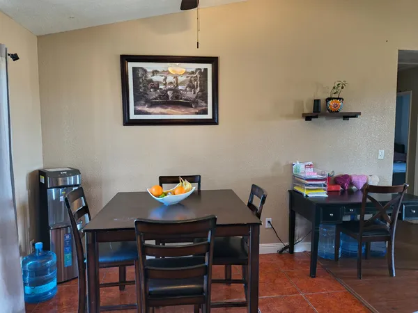 a view of a dining room with furniture and window