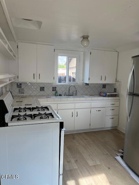 10510 Mather Avenue Sunland, CA 91040 - Photo 2 of 11 a kitchen with cabinets appliances a sink and a window