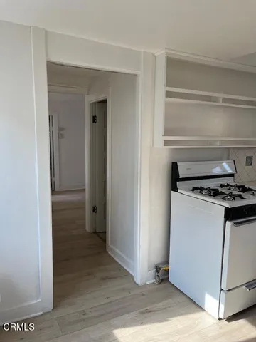 a stove top oven sitting inside of a kitchen