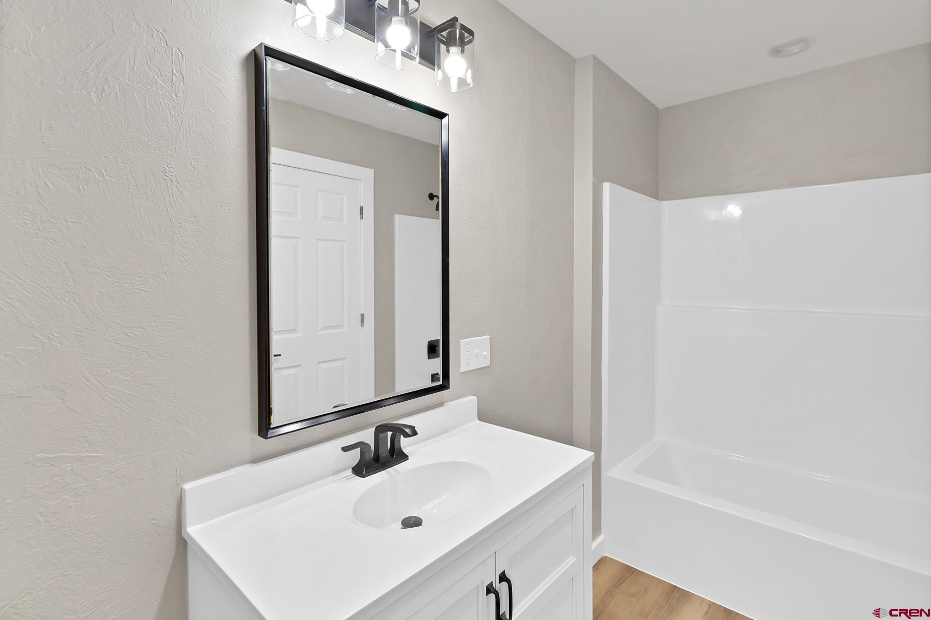 295 West 7th Street Delta, CO 81416 - Photo 2 of 34 a bathroom with a sink a shower and a mirror