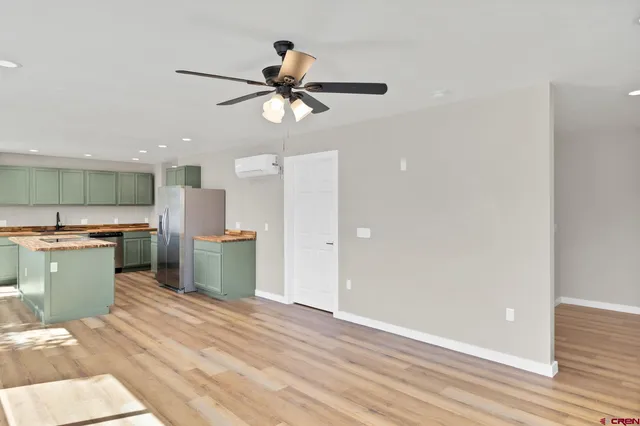 a kitchen with a refrigerator and a sink