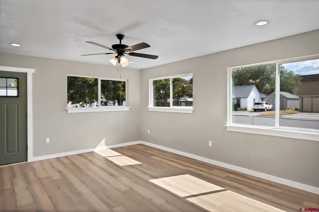 a view of a bedroom with wooden floor and a window