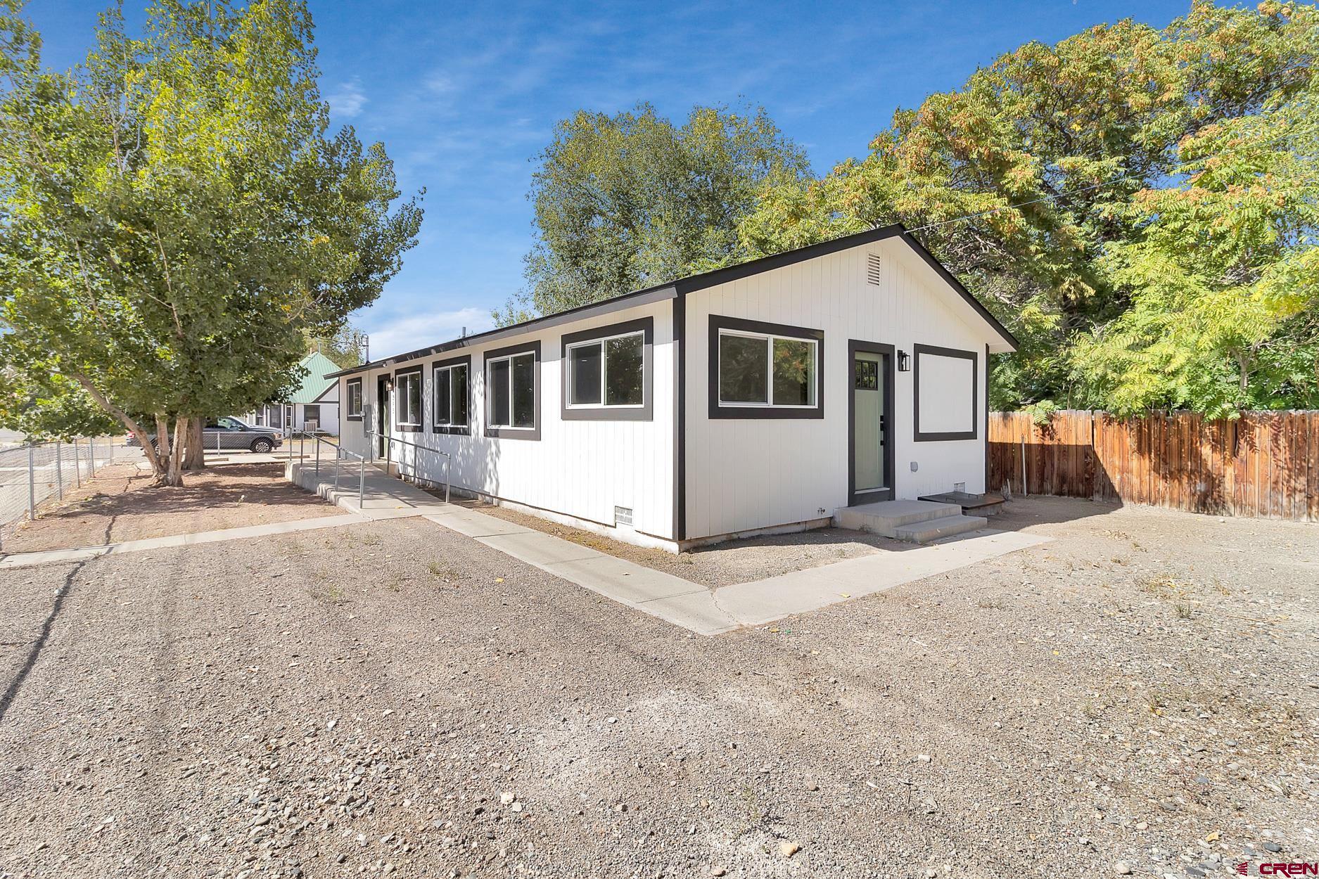295 West 7th Street Delta, CO 81416 - Photo 29 of 34 a view of a house with a yard and large tree
