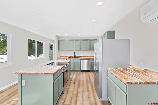a kitchen with a sink stove and refrigerator
