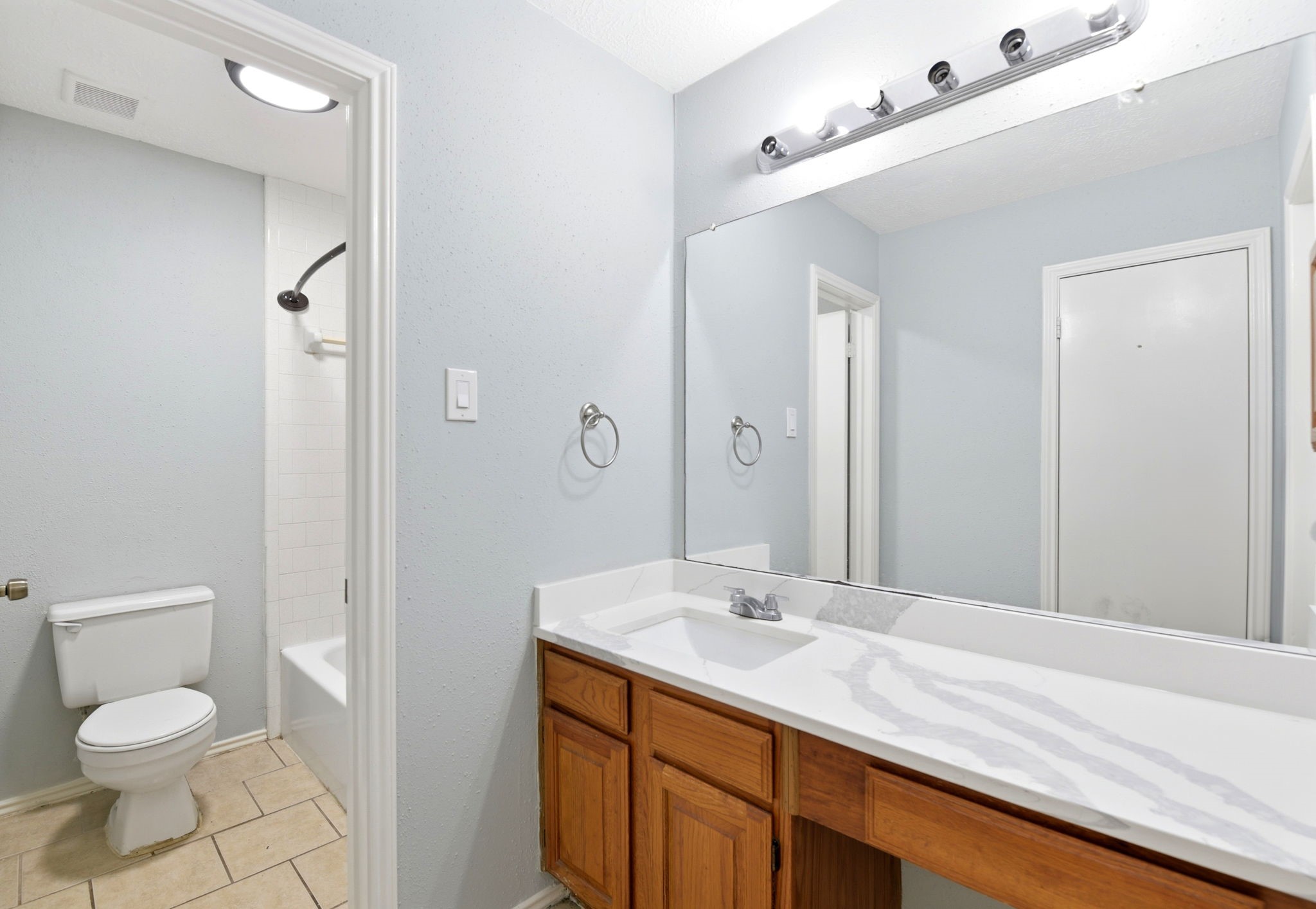21330 Golden Dove Drive Spring, TX 77388 - Photo 15 of 29 The en-suite primary bathroom features a long vanity with excellent counter space, upgraded lighting, and classic hardware.