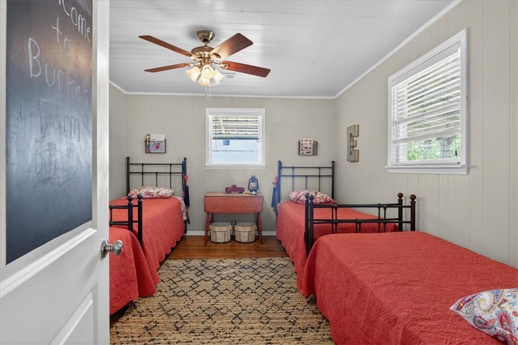 7433 Nicklesville Road Northeast Ranger, GA 30734 - Photo 11 of 53 a bedroom with a bed and a chandelier