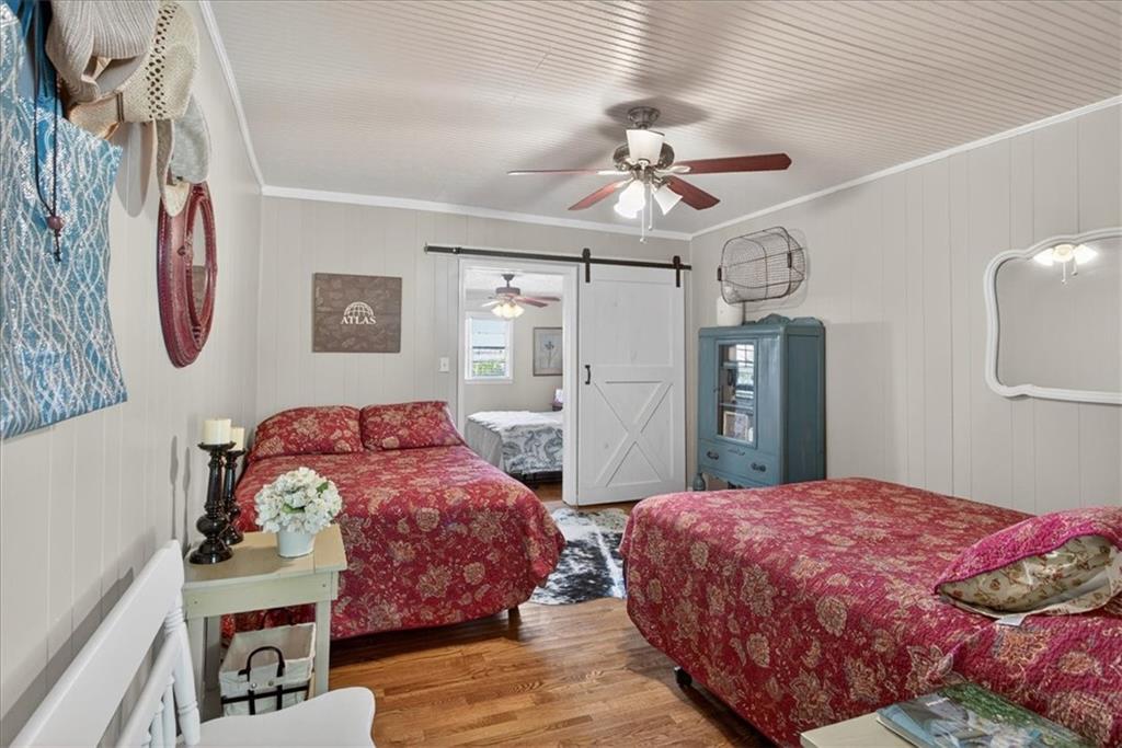 7433 Nicklesville Road Northeast Ranger, GA 30734 - Photo 13 of 53 a bedroom with double bed and a chandelier