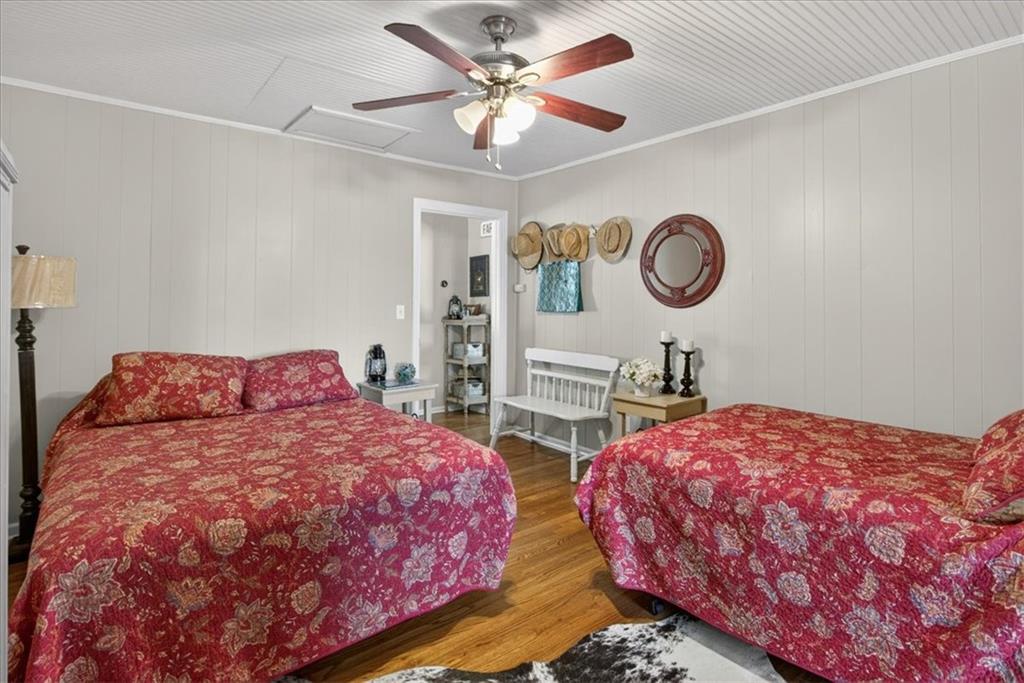 7433 Nicklesville Road Northeast Ranger, GA 30734 - Photo 14 of 53 a bedroom with a bed and a chandelier