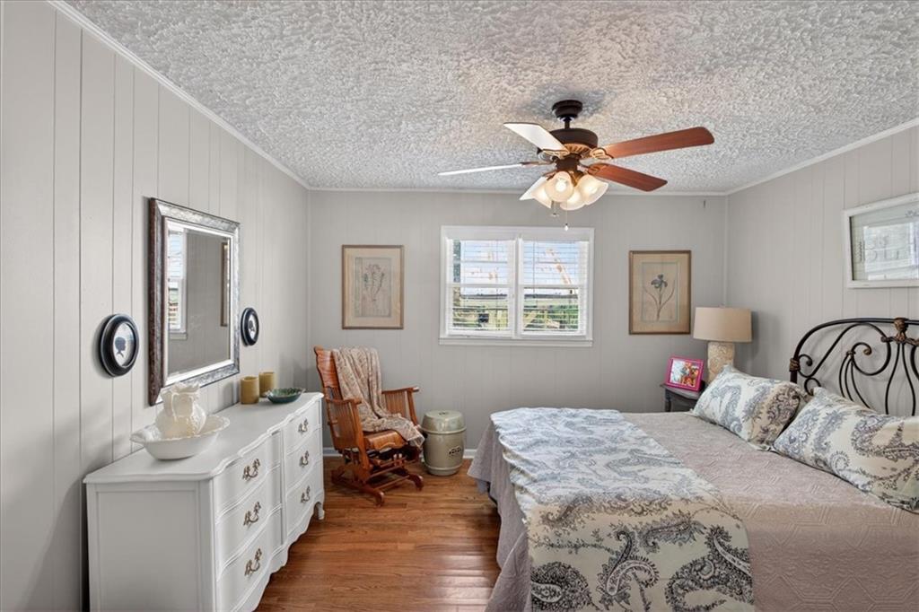 7433 Nicklesville Road Northeast Ranger, GA 30734 - Photo 15 of 53 a bedroom with a bed and a chandelier