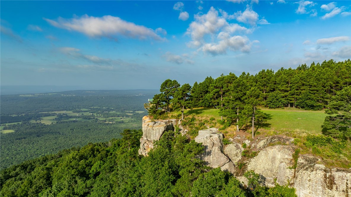 11334 Pool Holw Road Dardanelle, AR 72834 - Photo 45 of 50 Expansive cliffside property featuring rock formations, mature evergreen trees, and a grassy plateau overlooking extensive wooded terrain