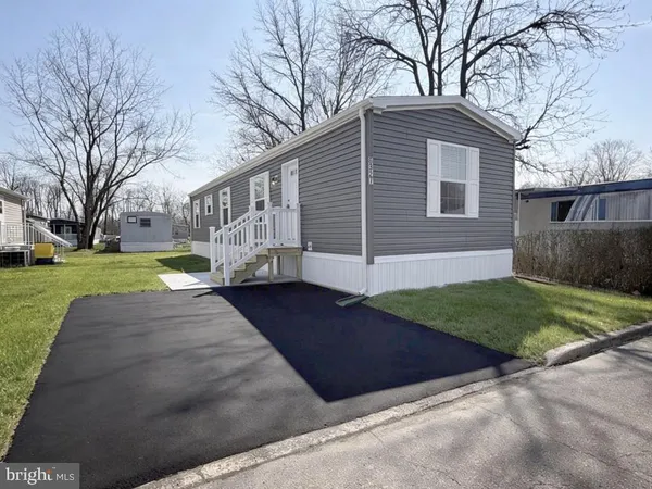a view of a yard in front view of a house