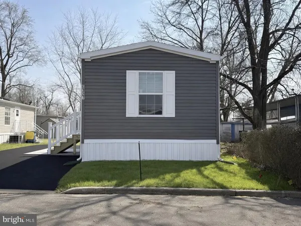 a view of brick house with a yard