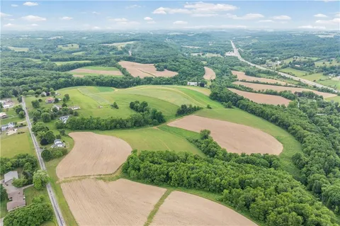 an aerial view of residential houses with outdoor space and river