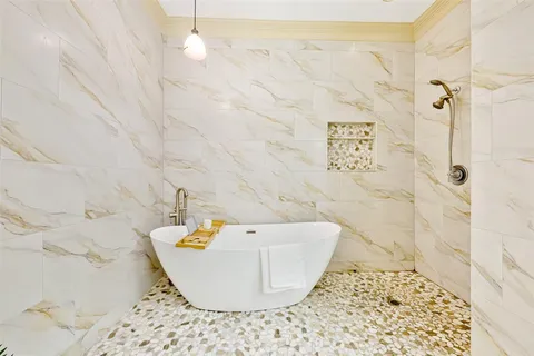 a bathroom with a bathtub and shower