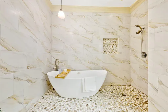 a bathroom with a bathtub and shower