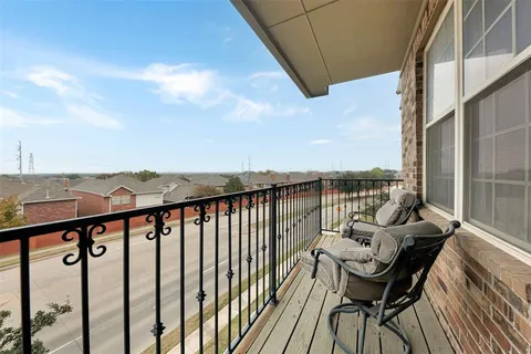 a roof deck with table and chairs and wooden floor