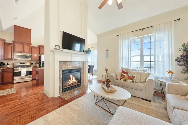 a living room with furniture a fireplace and a flat screen tv