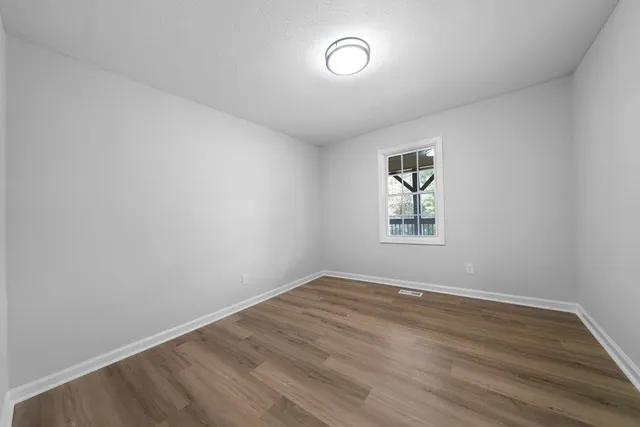 a view of room with wooden floor