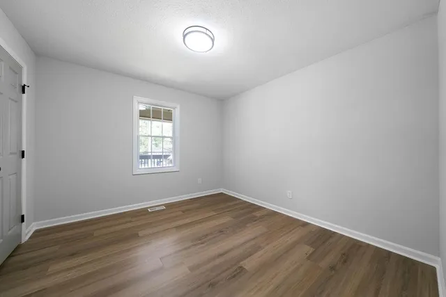 a view of room with wooden floor
