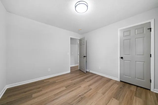 a view of a green field with wooden fence