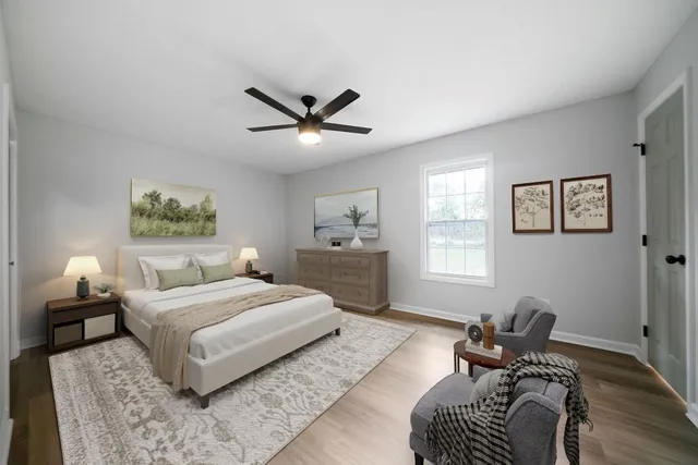 a bedroom with a bed couch and a window