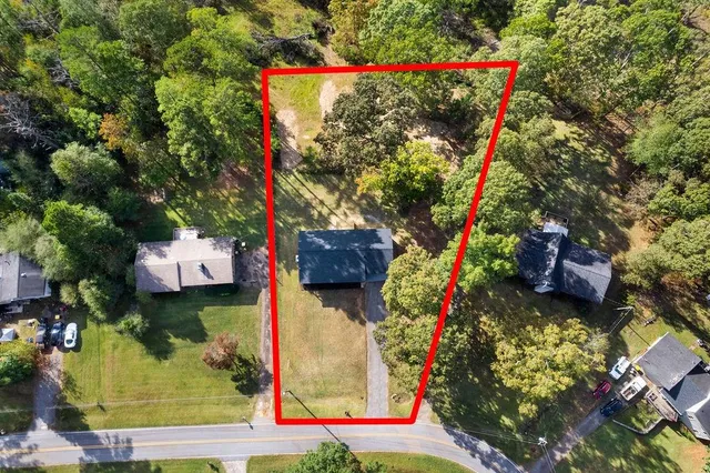 a view of house with yard and swimming pool