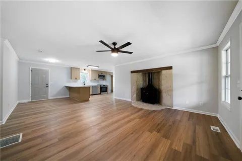 a view of a kitchen with sink and wooden floor