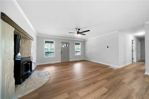 a kitchen with stainless steel appliances granite countertop a sink dishwasher a stove and a refrigerator with wooden floor