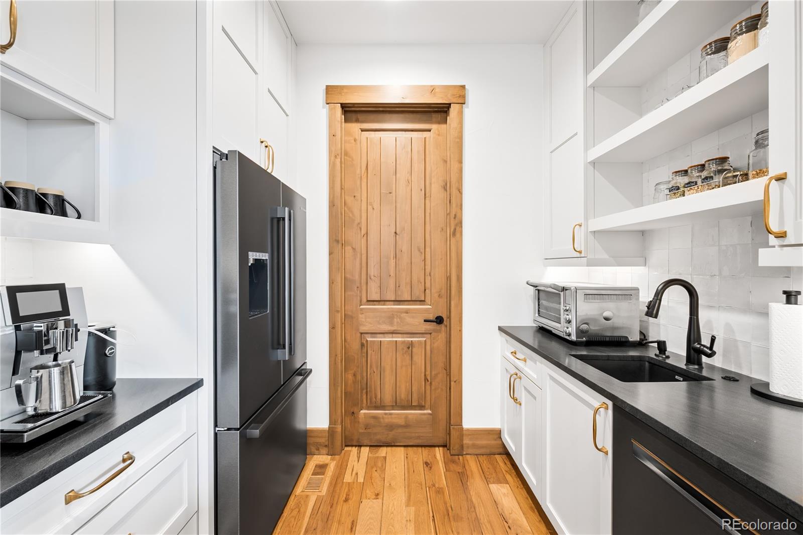 3148 Keep Drive Sedalia, CO 80135 - Photo 11 of 44 a kitchen with a refrigerator and a sink