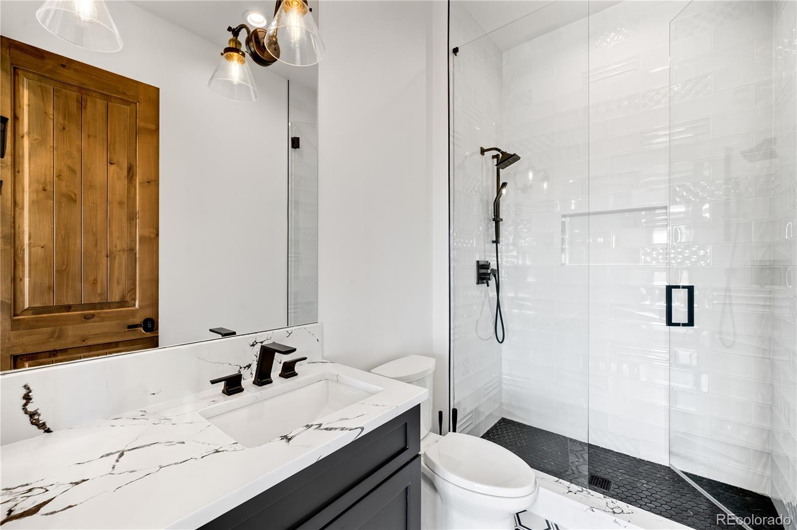 3148 Keep Drive Sedalia, CO 80135 - Photo 19 of 44 a bathroom with a sink toilet tub and shower