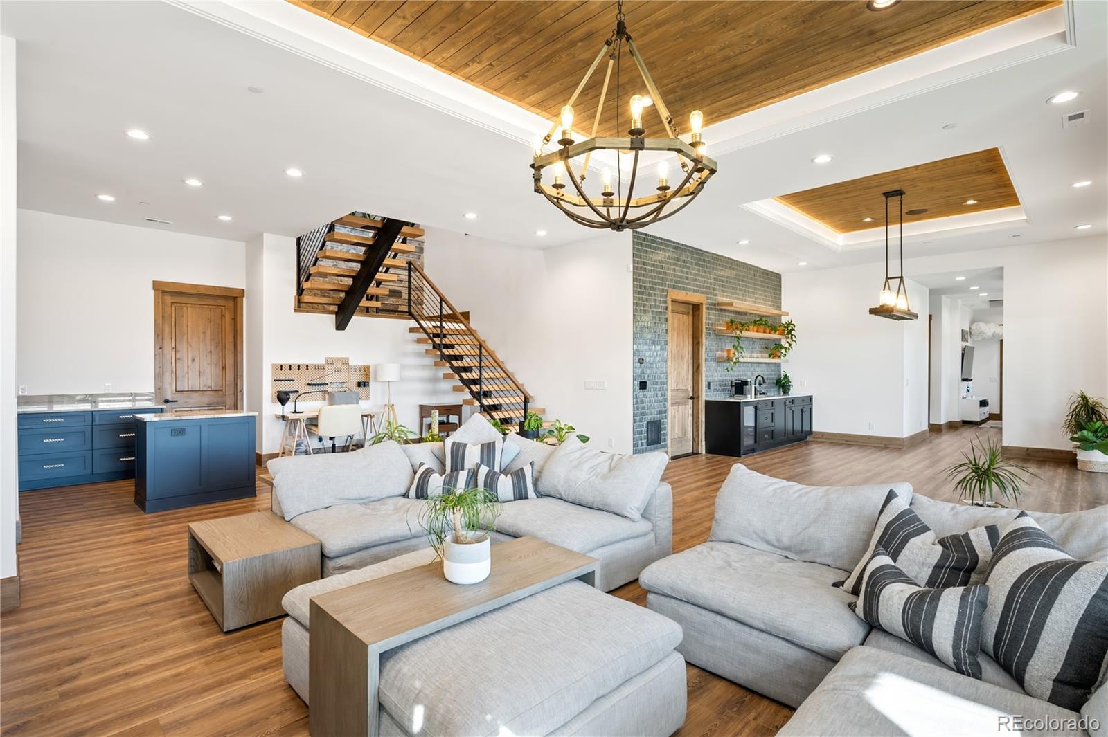 3148 Keep Drive Sedalia, CO 80135 - Photo 21 of 44 a living room with furniture a chandelier and a flat screen tv