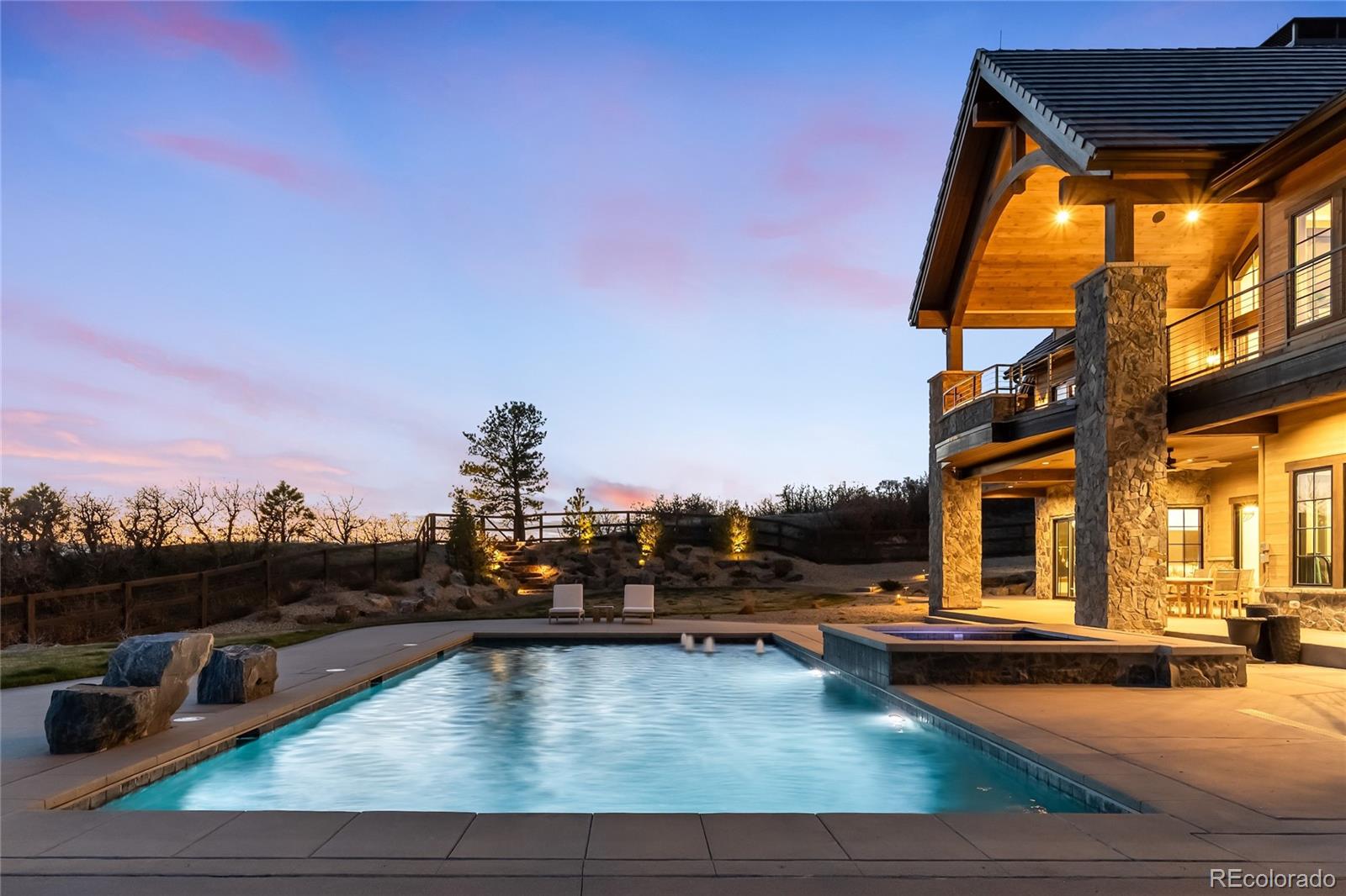 3148 Keep Drive Sedalia, CO 80135 - Photo 36 of 44 a view of a swimming pool with a lounge chairs