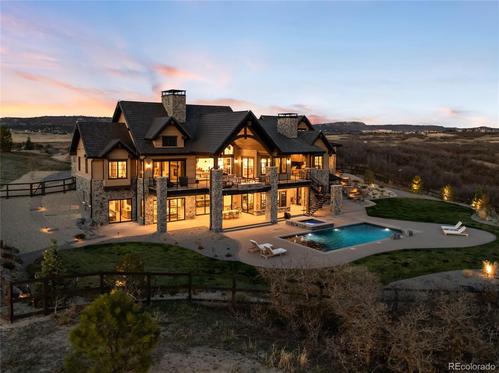3148 Keep Drive Sedalia, CO 80135 - Photo 42 of 44 a front view of house with yard and mountain in the background