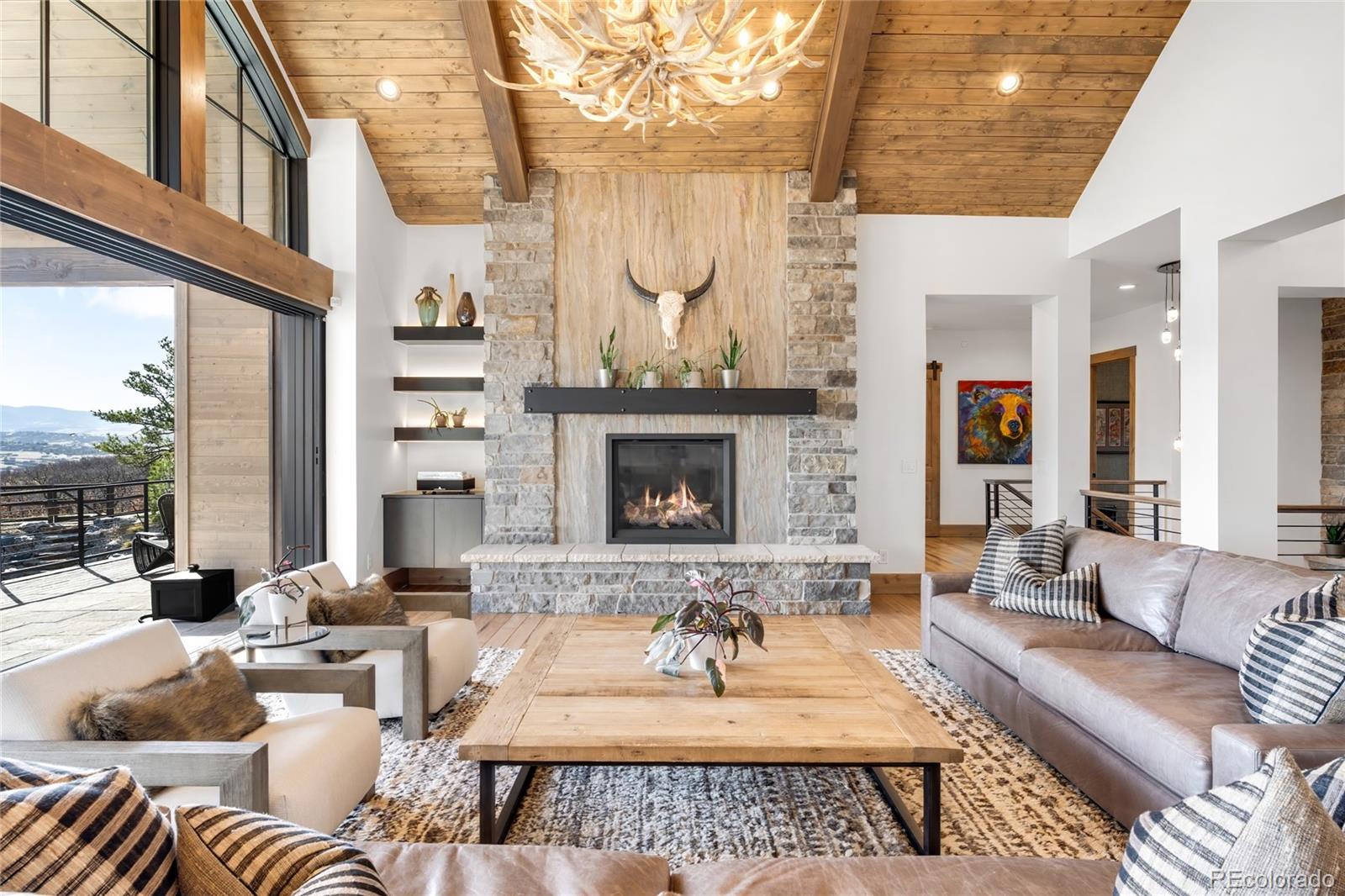 3148 Keep Drive Sedalia, CO 80135 - Photo 6 of 44 a living room with furniture a fireplace and a large window