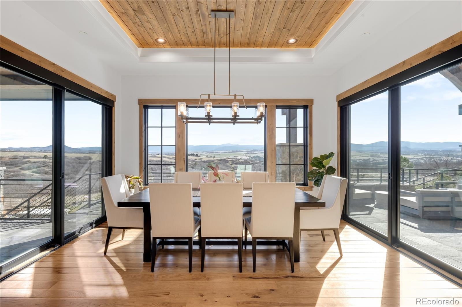 3148 Keep Drive Sedalia, CO 80135 - Photo 8 of 44 a dining room with furniture window and wooden floor