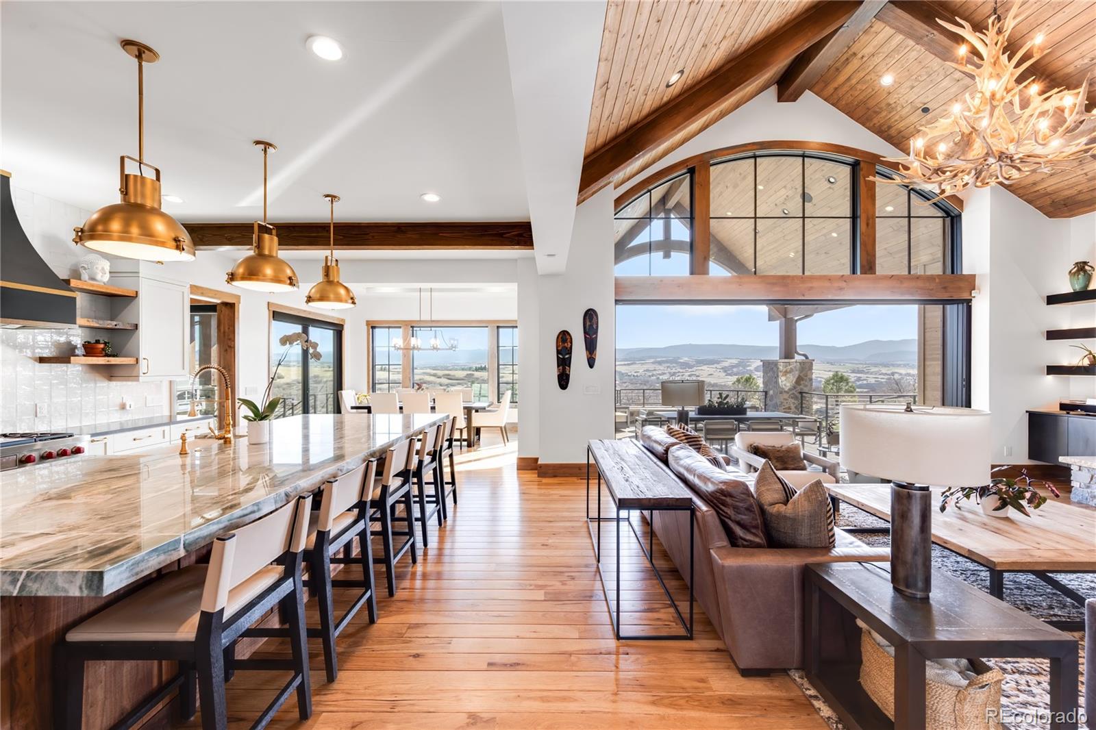 3148 Keep Drive Sedalia, CO 80135 - Photo 10 of 44 a dining room with wooden floor windows and a chandelier