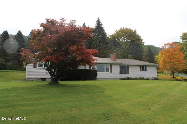 a view of house with a big yard