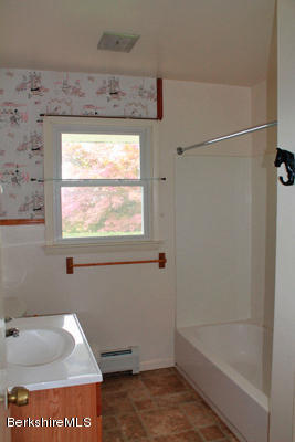 265 Yokun Road Richmond, MA 01201 - Photo 12 of 24 a bathroom with a bath tub and a window