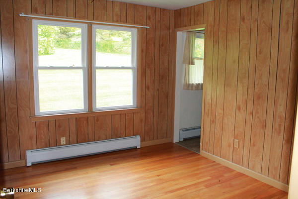 265 Yokun Road Richmond, MA 01201 - Photo 13 of 24 a view of an empty room with wooden floor and a window