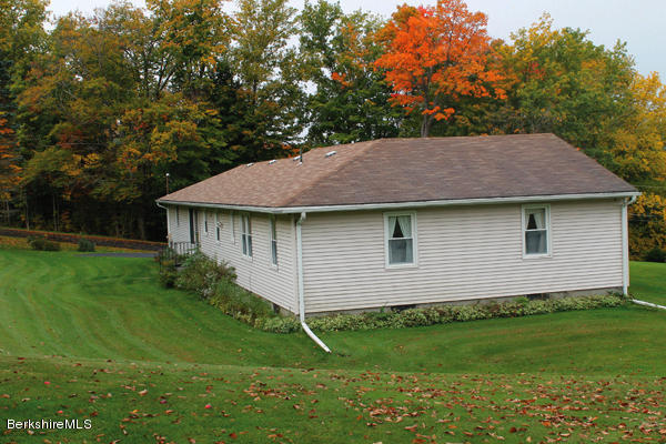 265 Yokun Road Richmond, MA 01201 - Photo 18 of 24 a front view of a house with a garden