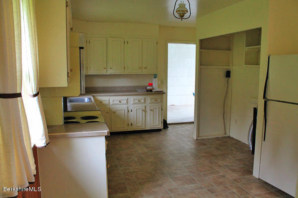 265 Yokun Road Richmond, MA 01201 - Photo 7 of 24 a kitchen with stainless steel appliances a refrigerator and a stove