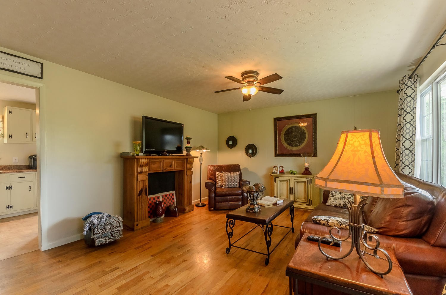8321 Shelton Road Corryton, TN 37721 - Photo 7 of 28 a living room with furniture a fireplace and a flat screen tv