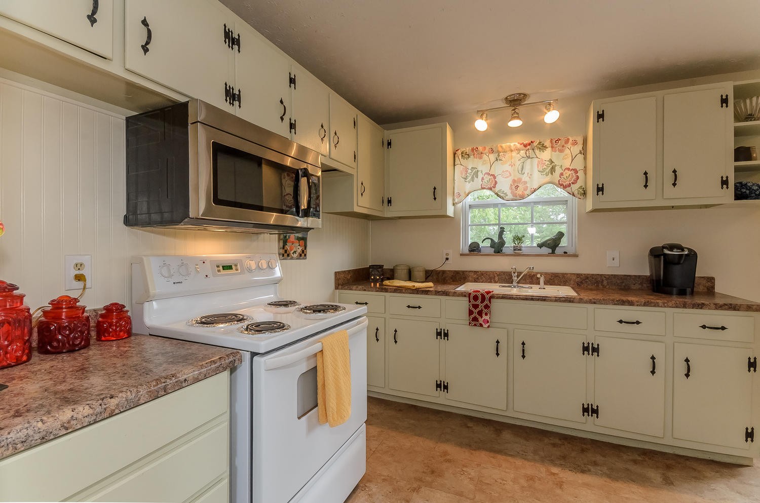 8321 Shelton Road Corryton, TN 37721 - Photo 9 of 28 a kitchen with stainless steel appliances granite countertop a sink a stove a microwave and cabinets