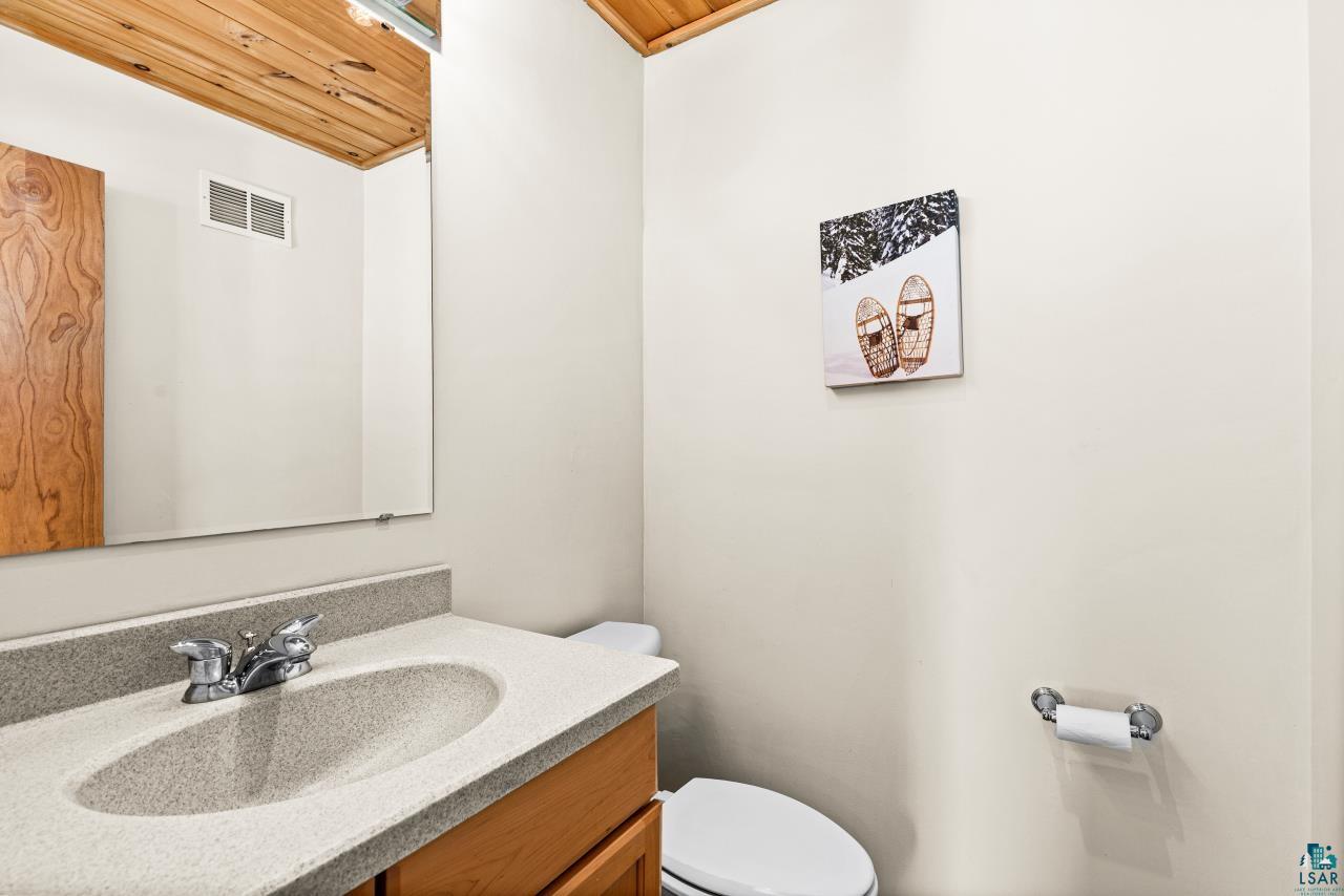 67 Snowshoe Trail Tofte, MN 55615 - Photo 26 of 42 Bathroom featuring vanity and wooden ceiling
