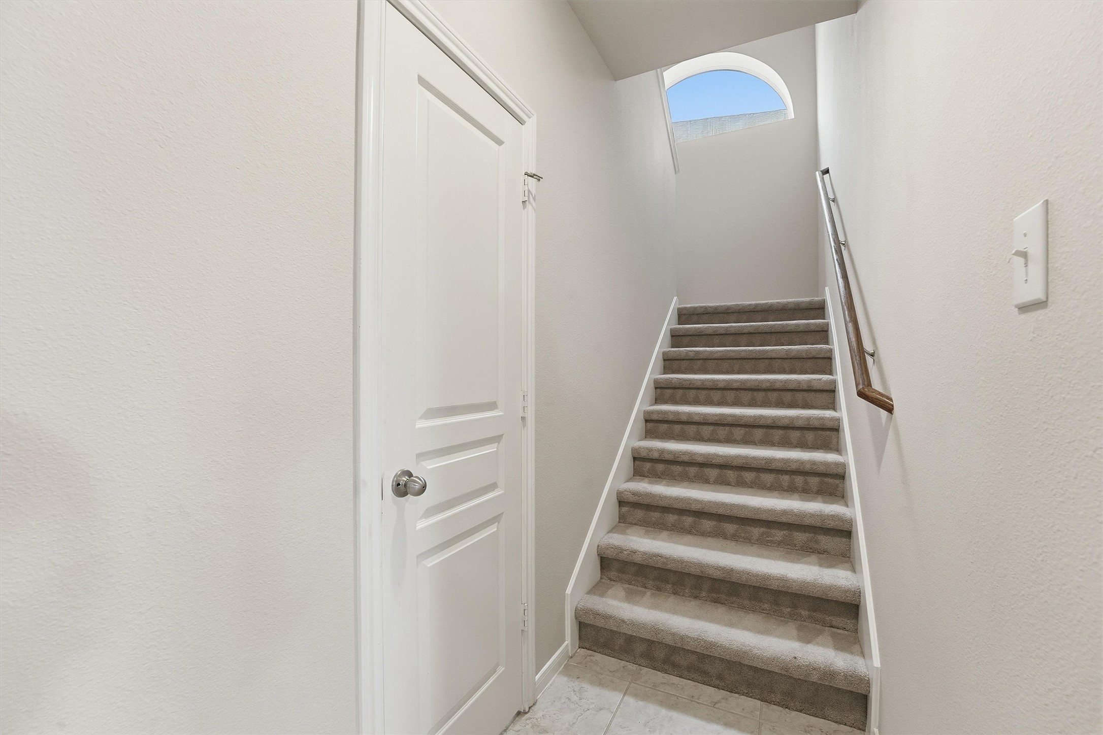 17415 Memorial Mills Drive Spring, TX 77379 - Photo 21 of 37 Secondary staircase provides convenient access between levels. The door shown to the left is the guest suite bathroom on the first floor. The kitchen is behind the wall to the right.