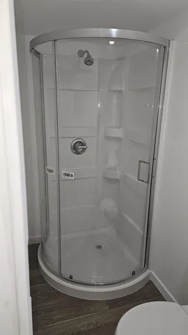 a bathroom with a glass shower door
