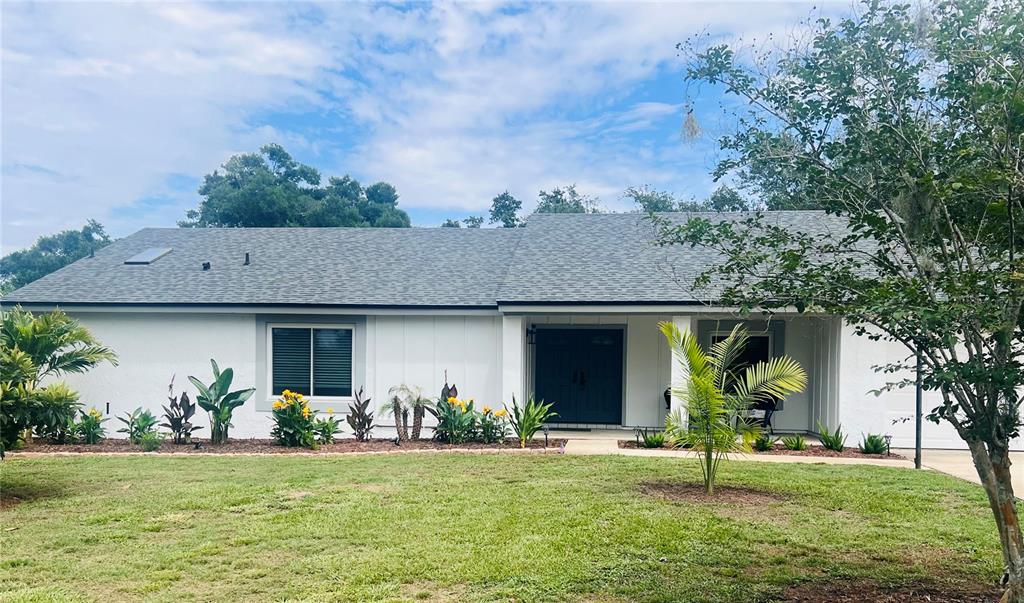 7432 Sparkling Lake Road Orlando, FL 32819 - Photo 1 of 54 a front view of a house with garden