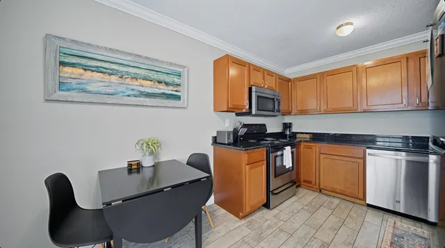 a kitchen with granite countertop a stove sink and cabinets